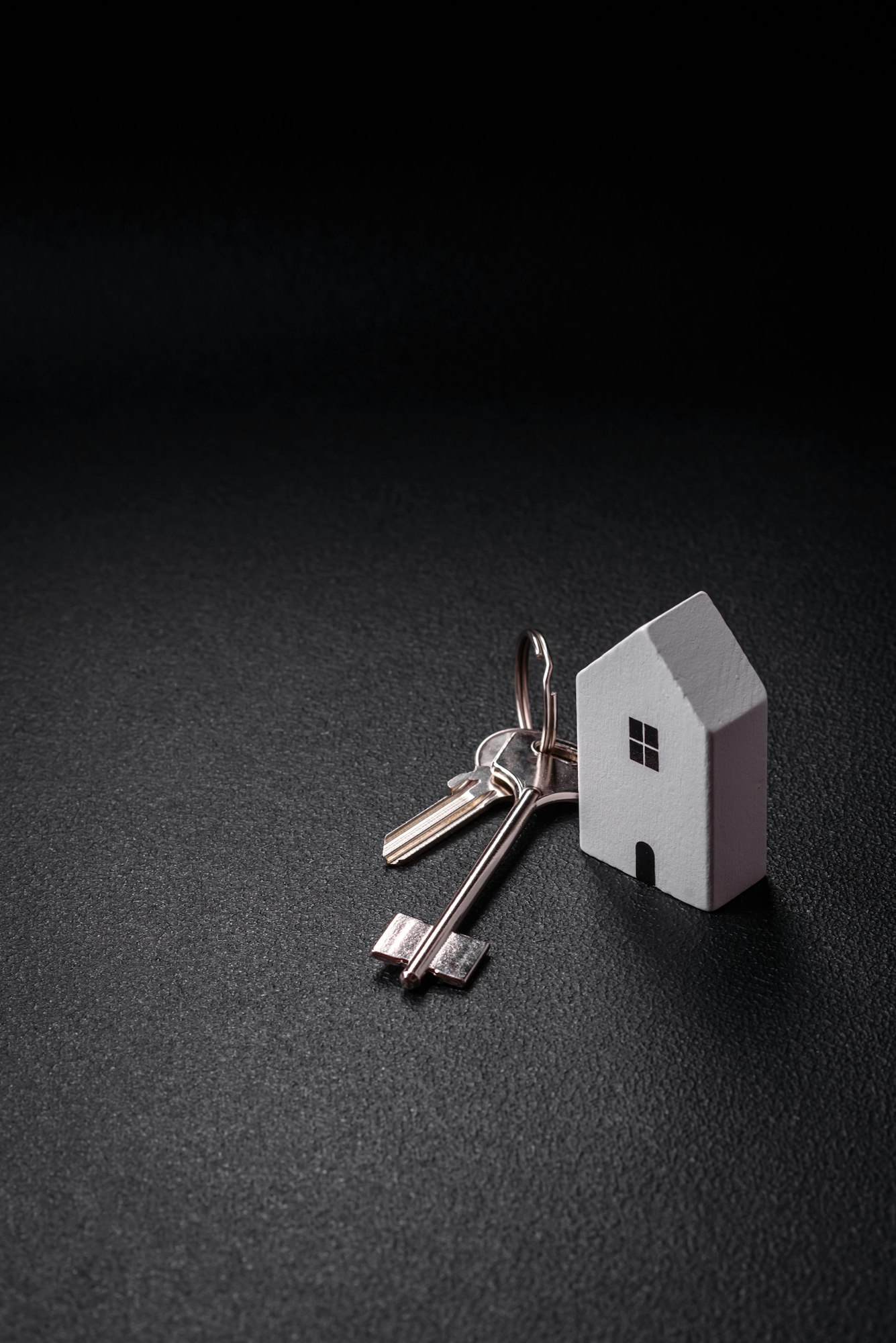 A small wooden house and keys as an idea for investing in your own home
